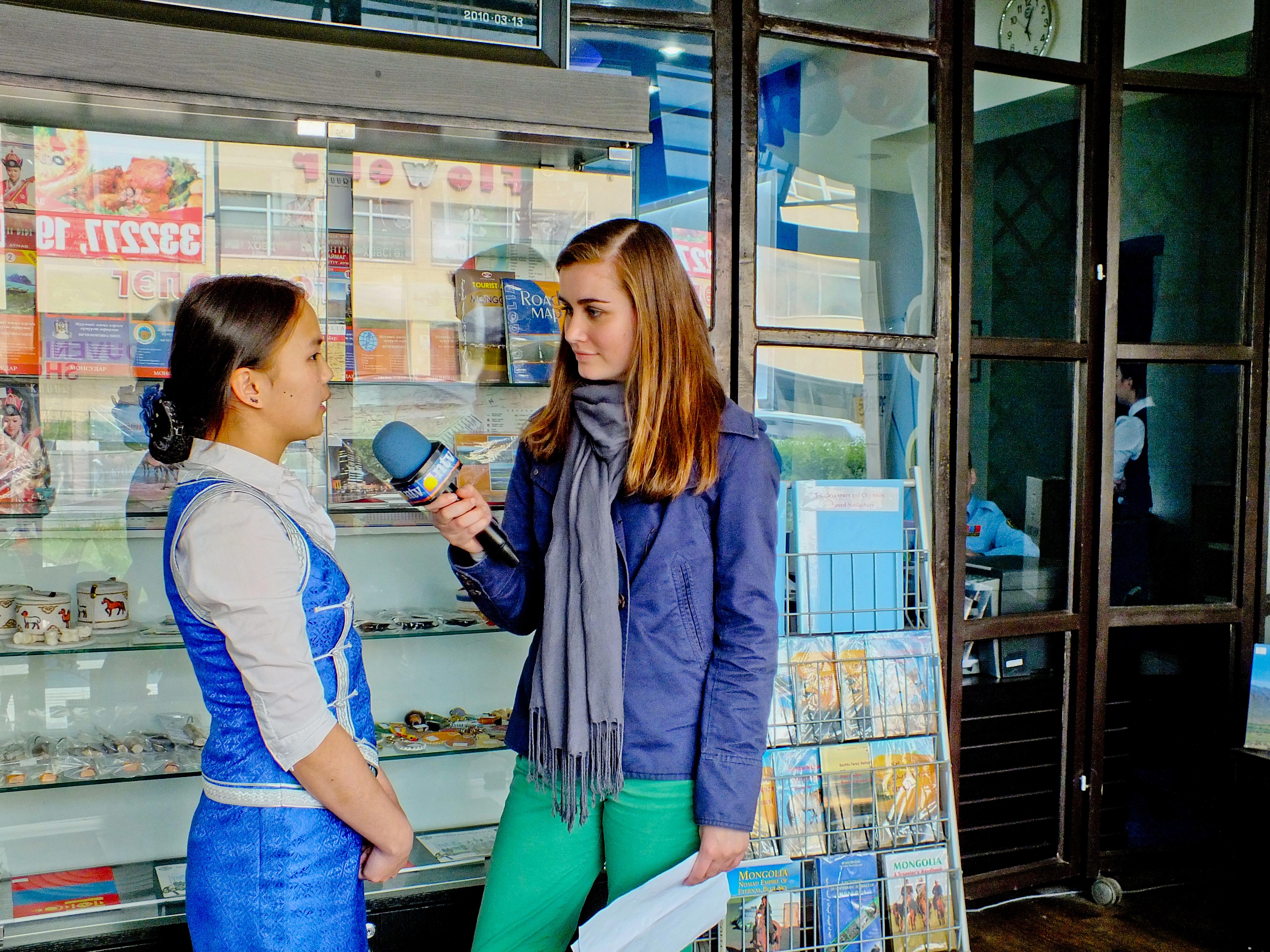 A Projects Abroad journalism intern interviews a woman at her placement in Mongolia A journalism intern in Mongolia speaks to a woman in the street